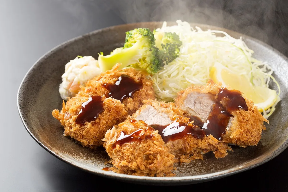 ソースのかかったとんかつの料理写真